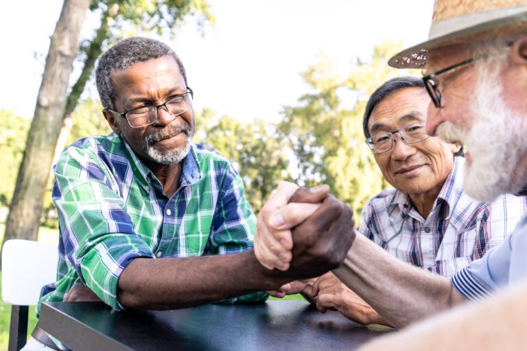 group-of-senior-friends-playing-arm-wrestling-at-t-2023-11-27-05-07-27-utc (1)