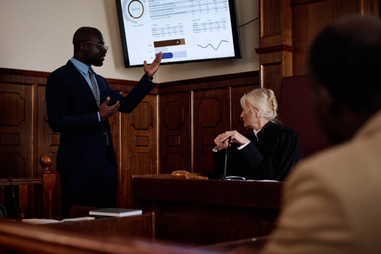 confident-male-lawyer-pointing-at-screen-with-summ-2023-11-27-05-13-06-utc (1)